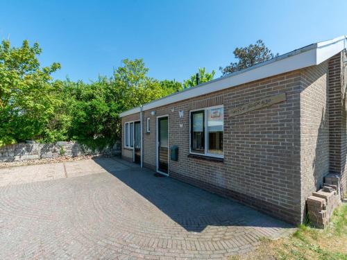 a brick building with a window on the side of it at Holiday Home Callantsoog near Beach in Callantsoog