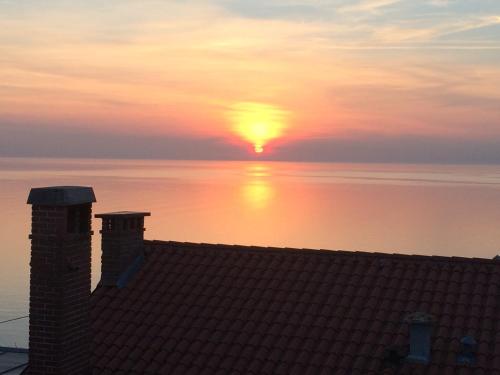 a sunset from the roof of a house at Apartments Mirjana in Piran