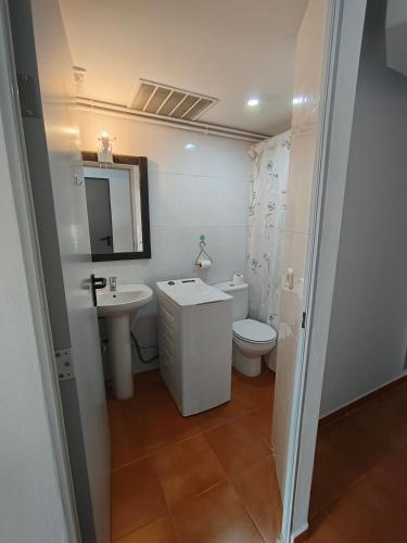 a bathroom with a sink and a toilet and a mirror at Casaemy in Pineda de Mar