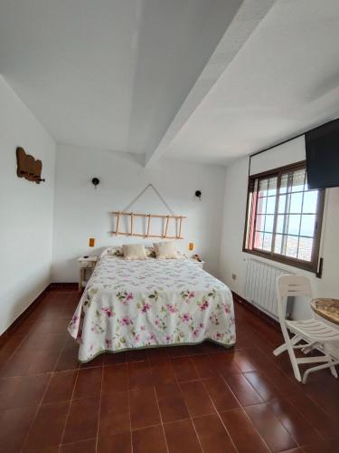 a bedroom with a bed and a table and chairs at Casaemy in Pineda de Mar