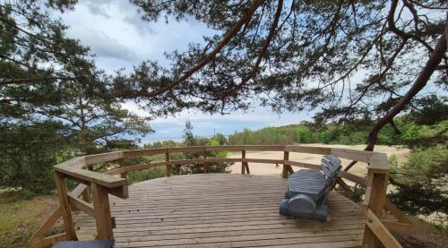 a backpack is sitting on a wooden bridge at Budas in Plieņciems