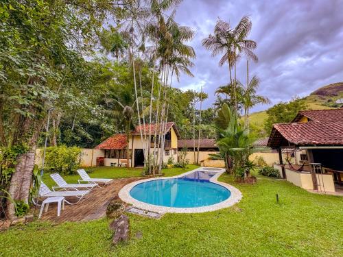 una casa con piscina en el patio en Casa Pindorama - Chalé Opy, en Paraty