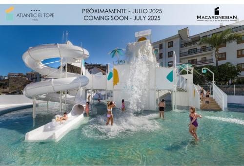 a group of people in the water at a water park at Hotel Atlantic El Tope in Puerto de la Cruz