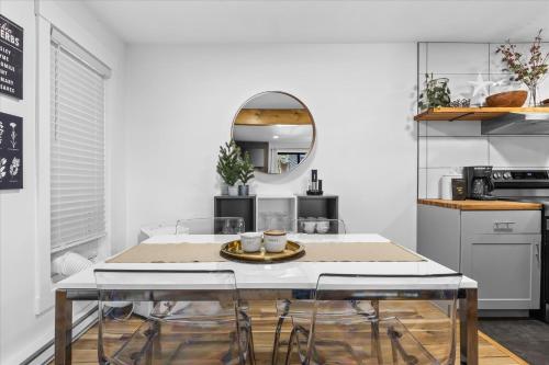 a kitchen with a table with chairs and a mirror at Relaxed 1BR Mountain Escape w Fireplace & Parking in Steamboat Springs