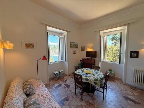 a living room with a table and a couch at Panoramic Apartments in Villa in Center "The Beach and The Cliff" 1 in Agropoli