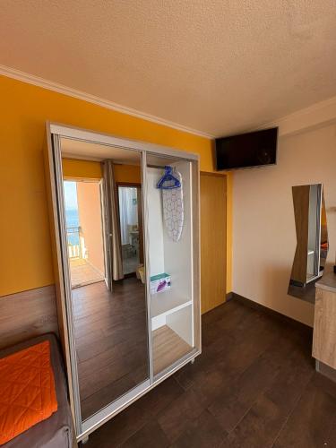 a room with a sliding glass door with a balcony at Apartments PEHAR in Podaca