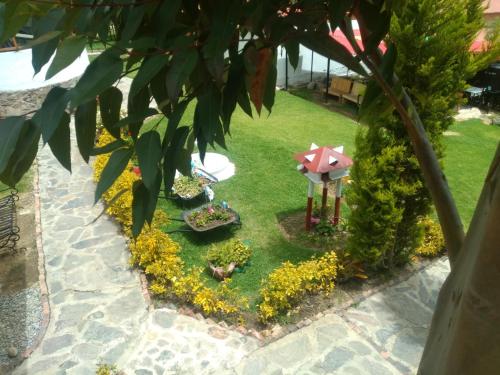 a miniature garden with flowers and an umbrella at El Rincón de Gabo in Nobsa