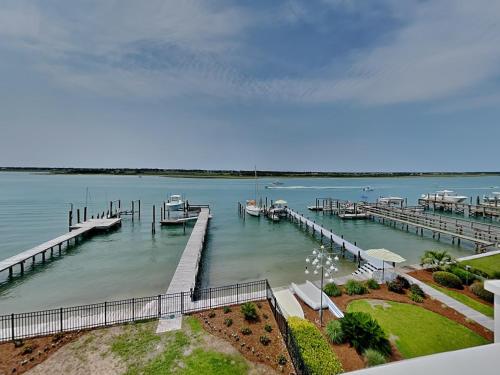 a dock with boats in a large body of water at Channel 6 in Surf City