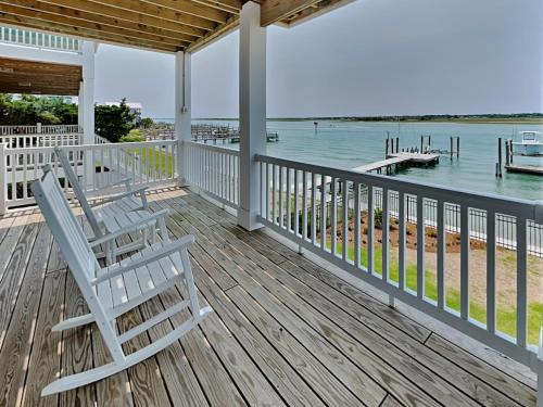 two chairs sitting on a deck with the water at Channel 6 in Surf City