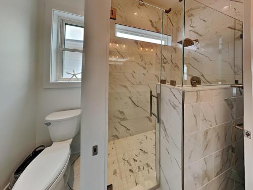 a bathroom with a toilet and a shower at Channel 6 in Surf City