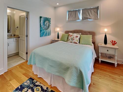 a bedroom with a large bed with green pillows at Channel 6 in Surf City