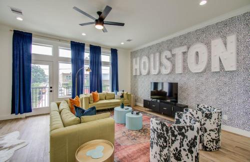 a living room with a houston sign on the wall at HTX Modern Retreat with Rooftop Cinema in Houston
