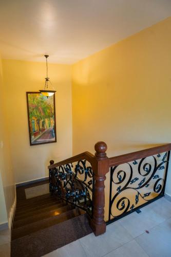 a staircase in a house with a painting on the wall at Resort Palmeiras Dourado in Cansaulim