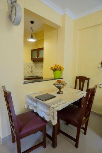 a kitchen with a table with chairs and a table and a tableablish at Resort Palmeiras Dourado in Cansaulim