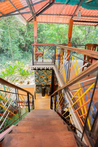 a wooden walkway with a bench on top of it at Resort Palmeiras Dourado in Cansaulim