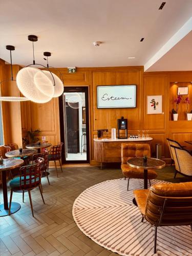 a restaurant with wooden walls and tables and chairs at Esteem Tour Eiffel in Paris