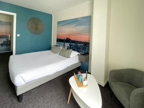a hotel room with a bed and a couch at Best Western ARThotel in Le Havre