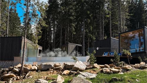 a house in the woods with a fire place at Hotel Björnson & Björnson TREE HOUSES Jasná in Demanovska Dolina