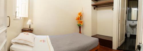 a hospital room with a bed and a vase of flowers at Hospedaje Santa Rosa- Centro Histórico in Lima