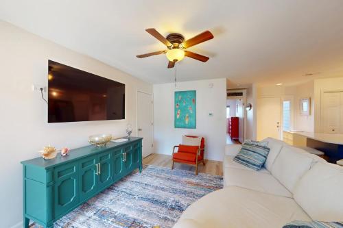 a living room with a white couch and a ceiling fan at East of the Sun --- 39620 E Sun Drive #715 in Fenwick Island