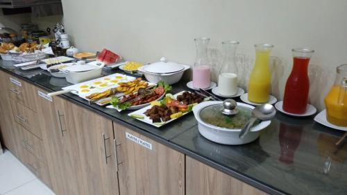 a buffet with many plates of food on a counter at Bora Hotel in Iquitos