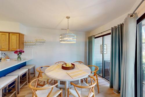 a kitchen and dining room with a table and chairs at East of the Sun --- 39620 E Sun Drive #715 in Fenwick Island