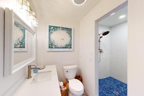 a bathroom with a sink and a toilet and a shower at East of the Sun --- 39620 E Sun Drive #715 in Fenwick Island
