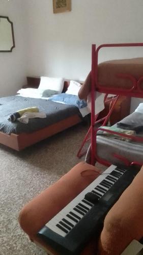 a room with two beds and a keyboard in it at Casa venturini in Imola