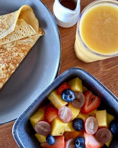 a table with a bowl of fruit and a plate of toast at El Resort de Yanashpa - Tarapoto in Tarapoto