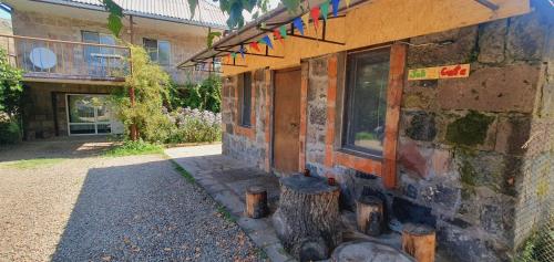 a building with a tree stump in front of it at Geologist's House in Garrgarr
