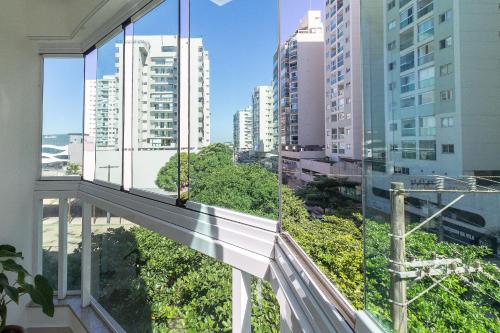 a balcony with a view of a city at 2Q Casal • Suíte c/ AC • Vista • 2º Andar • NOMDS in Itaparica