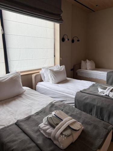 a room with two beds with towels on them at GirskiDelux in Bukovel