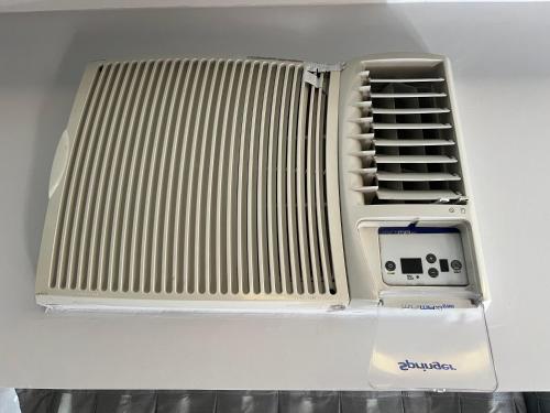 a white radiator sitting on top of a table at Hotel Live Logde Vila Mariana Pq Ibirapuera UH- 1108 in Sao Paulo