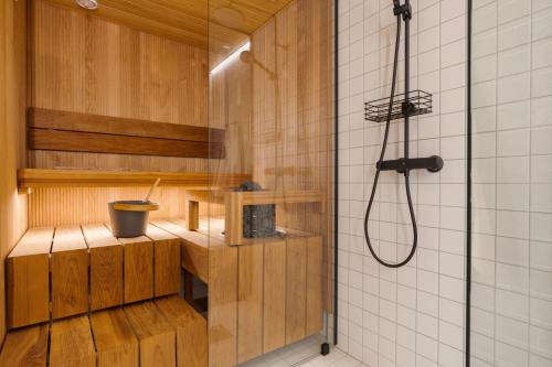 a shower in a bathroom with a glass shower stall at Auroras by Kaltios, Gielas, Ski-in Ski-out, Mountain view in Kittilä