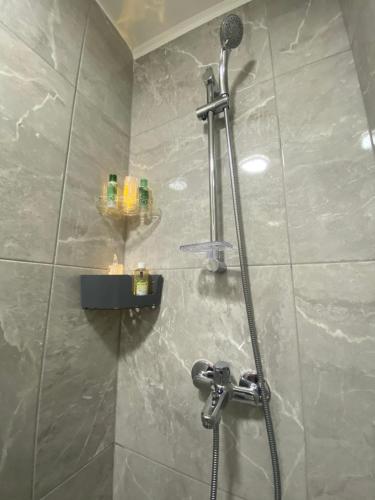 une douche dans une salle de bain avec une pomme de douche dans l'établissement Mackenzie By the sea one bed Ground floor home, à Larnaka