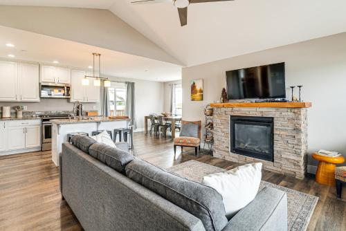 a living room with a couch and a fireplace at Hot Tub Modern Ocean Shores Home, 2 Mi to Beach! in Ocean Shores