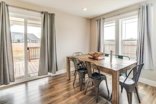 a dining room with a wooden table and chairs at Hot Tub Modern Ocean Shores Home, 2 Mi to Beach! in Ocean Shores