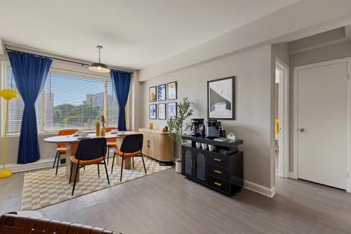 a living room and dining room with a table and chairs at CASA Arlington Suite with Top-Tier Amenities & Parking in Arlington