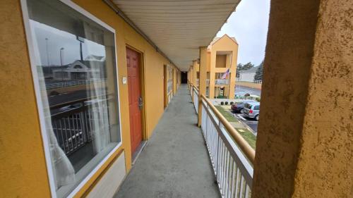 an empty hallway of a building with a window at Copley Inn & Suites By OYO Akron OH in Akron