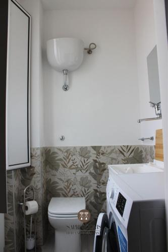 a small bathroom with a toilet and a sink at Sapri Rooms in Lamezia Terme