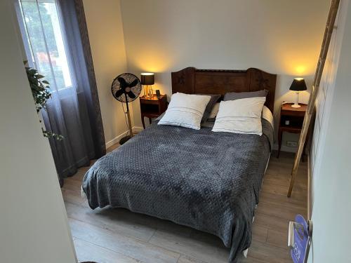 - une chambre avec un lit avec deux oreillers et un ventilateur dans l'établissement Appartement, Canet-Plage centre, à Canet