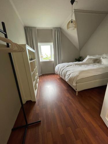 a bedroom with a bed and a wooden floor at High rated private appartment 350 m from Ålesund center with free parking in Ålesund