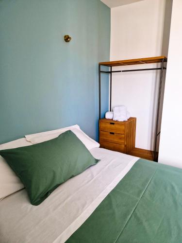a bedroom with a green pillow on a bed at Dimora Odigitria in Bitritto