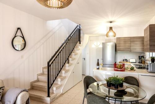 a kitchen and living room with a staircase and a table at Larnaca Seaside Villa Marina 43 in Perivolia