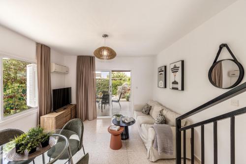 a living room with a couch and a table at Larnaca Seaside Villa Marina 43 in Perivolia