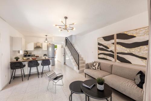 a living room with a couch and a kitchen at Larnaca Seaside Villa Marina 44 in Perivolia