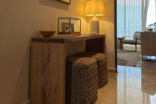 a living room with a table and a stool and a table at Alonisos Luxury Apartment in San Bruno