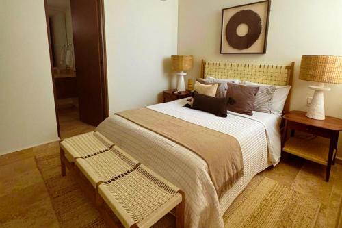 a bedroom with a large bed and two tables at Alonisos Luxury Apartment in San Bruno