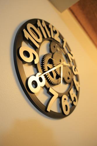 a black and white clock on a wall at AG Home in Kampala