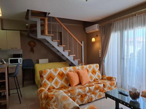 a living room with a couch and a staircase at Aggelos Elegant Stay City Center in Ioannina
